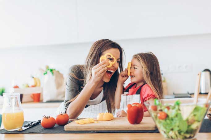 Woman and child cooking in a kitchen